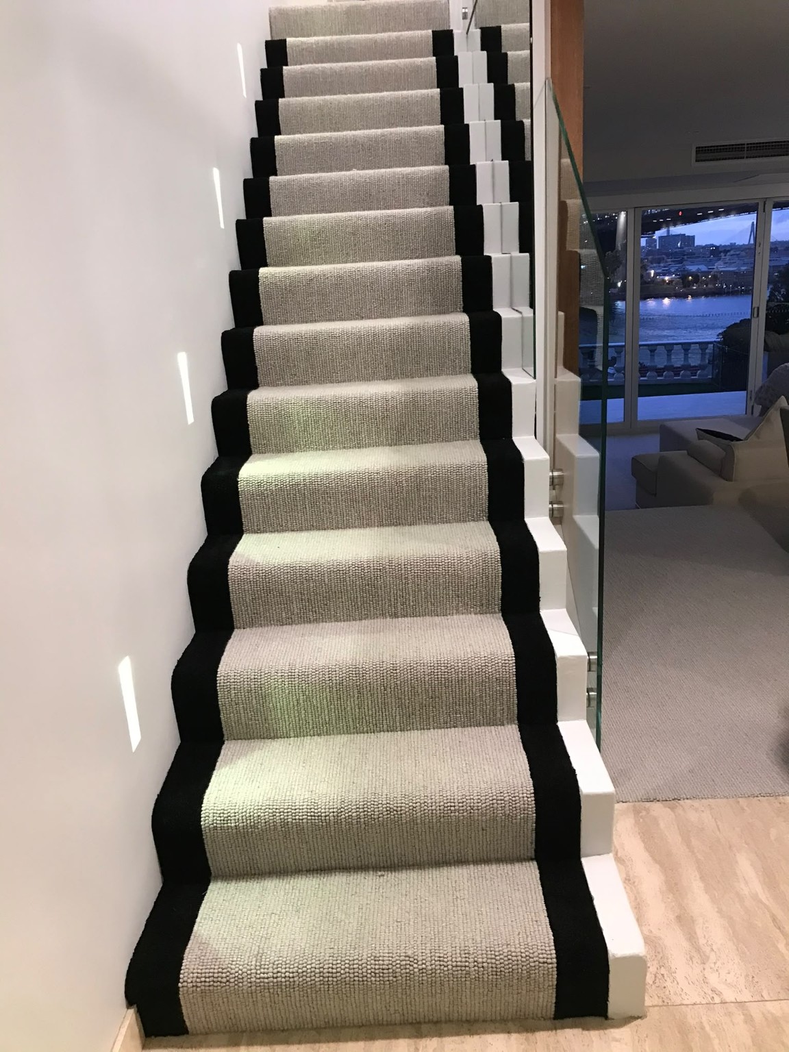 Decorative bordered carpet installed on a residential staircase